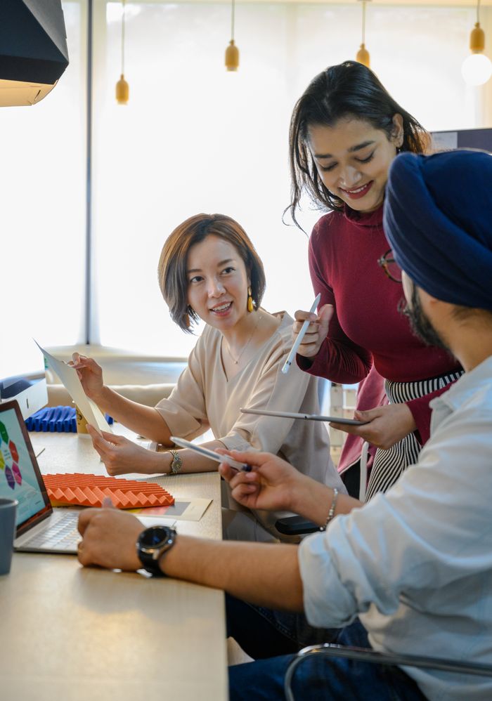 Group of professionals engaged in teamwork at a contemporary office space.